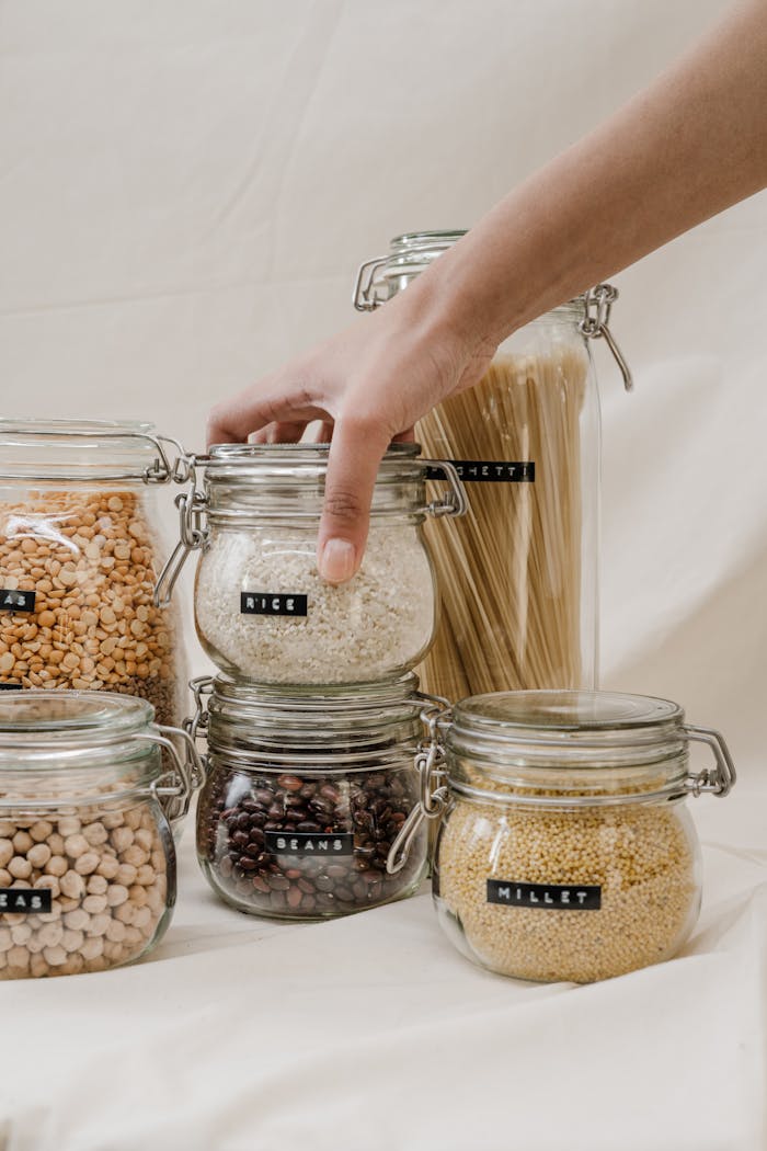 who-we-are Eco-friendly storage jars filled with grains, beans, and pasta, promoting a zero waste lifestyle.